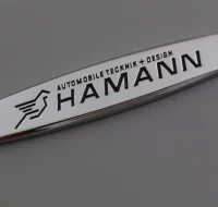 EMBLEMA METALICO LOGO HAMANN MATE